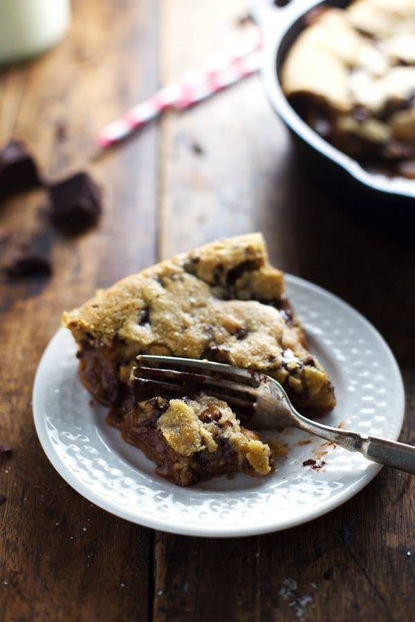 Deep Dish Chocolate Chip Cookie slice on a plate with a fork.