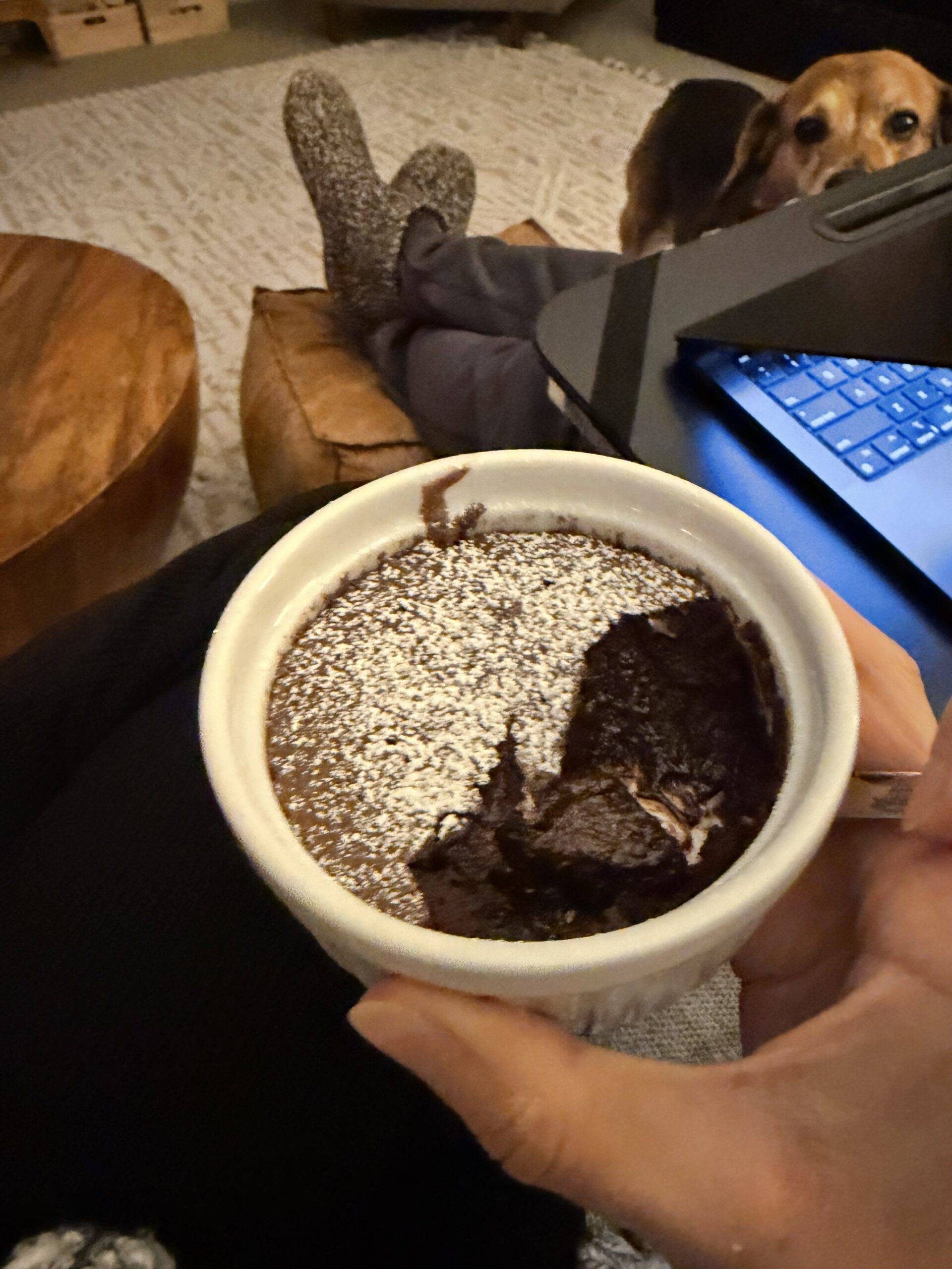 Hand holding single serving brownie pudding.
