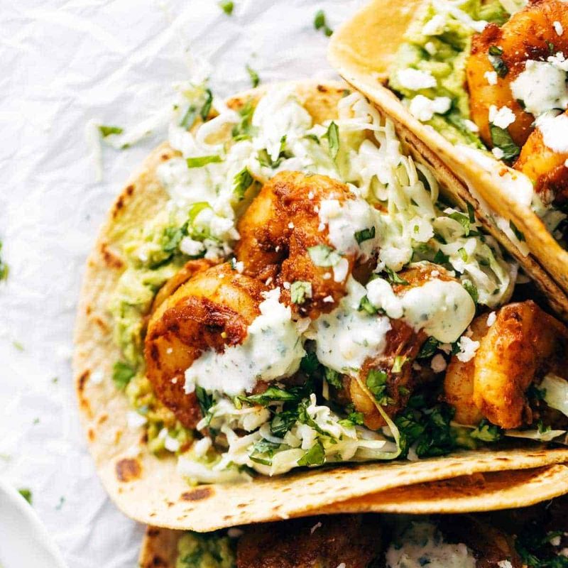 Shrimp tacos with sauce.