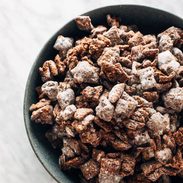 Big bowl of puppy chow being set down by a white hand.