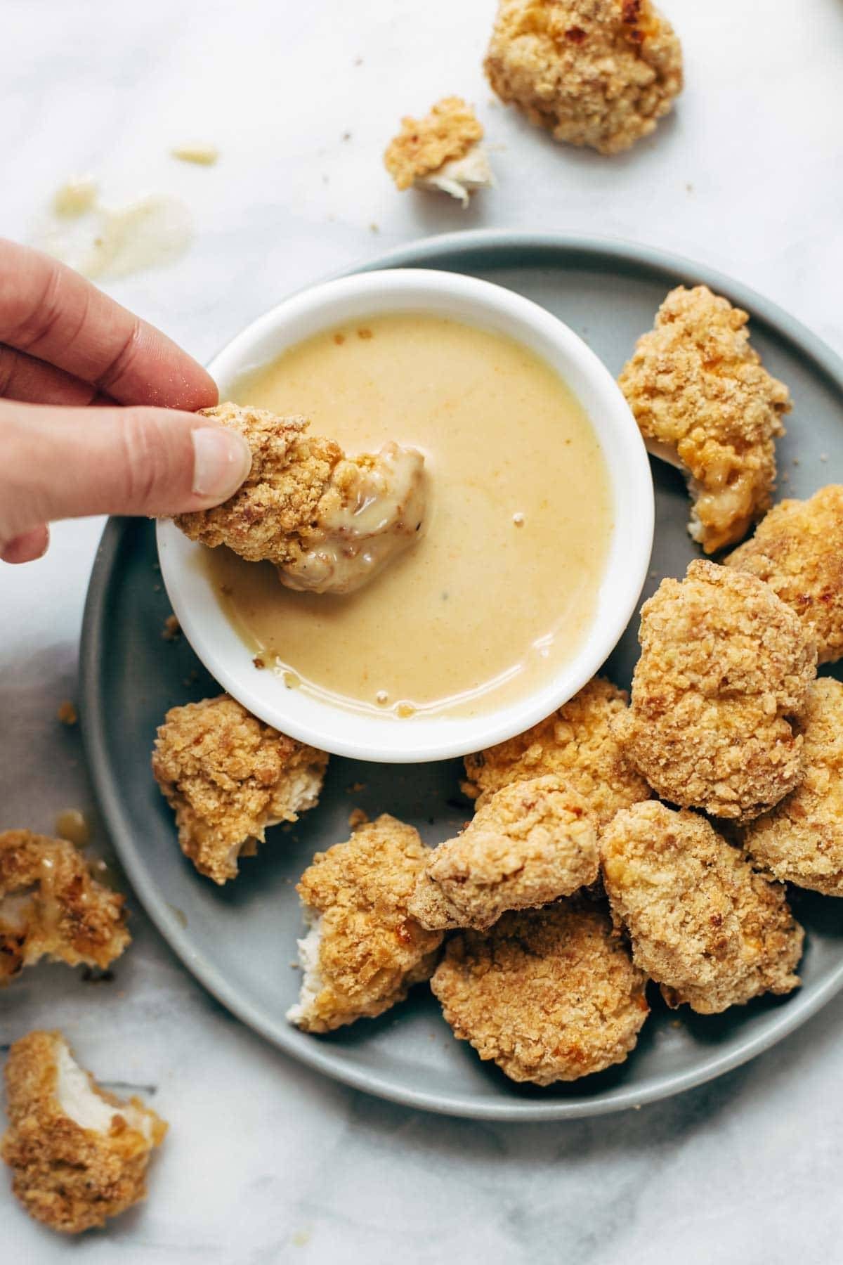 Everyone LOVES these! Baked popcorn chicken that tastes fried! Easy recipe, ready in 30 minutes. SO yummy and fun to share! | pinchofyum.com