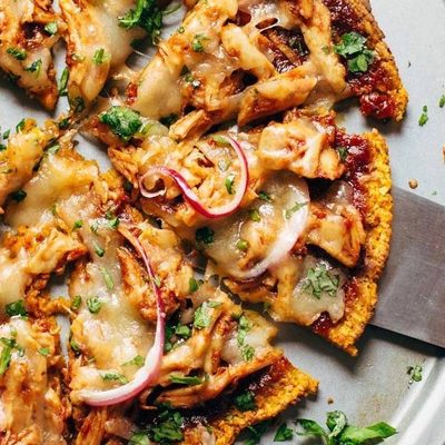 Sweet Potato Pizza on pizza pan with spatula.