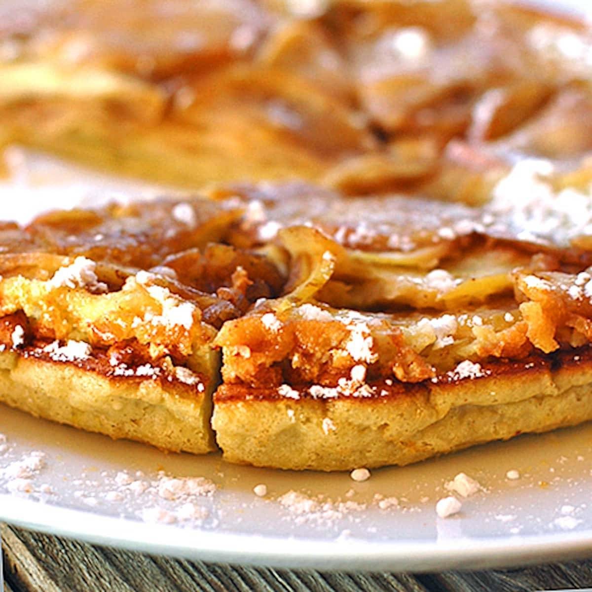 Baked apple pancake is baked in a cast iron skillet and topped with a homemade apple cider syrup.
