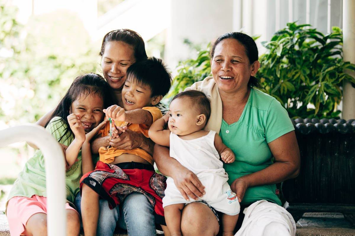 Two women with three young children.