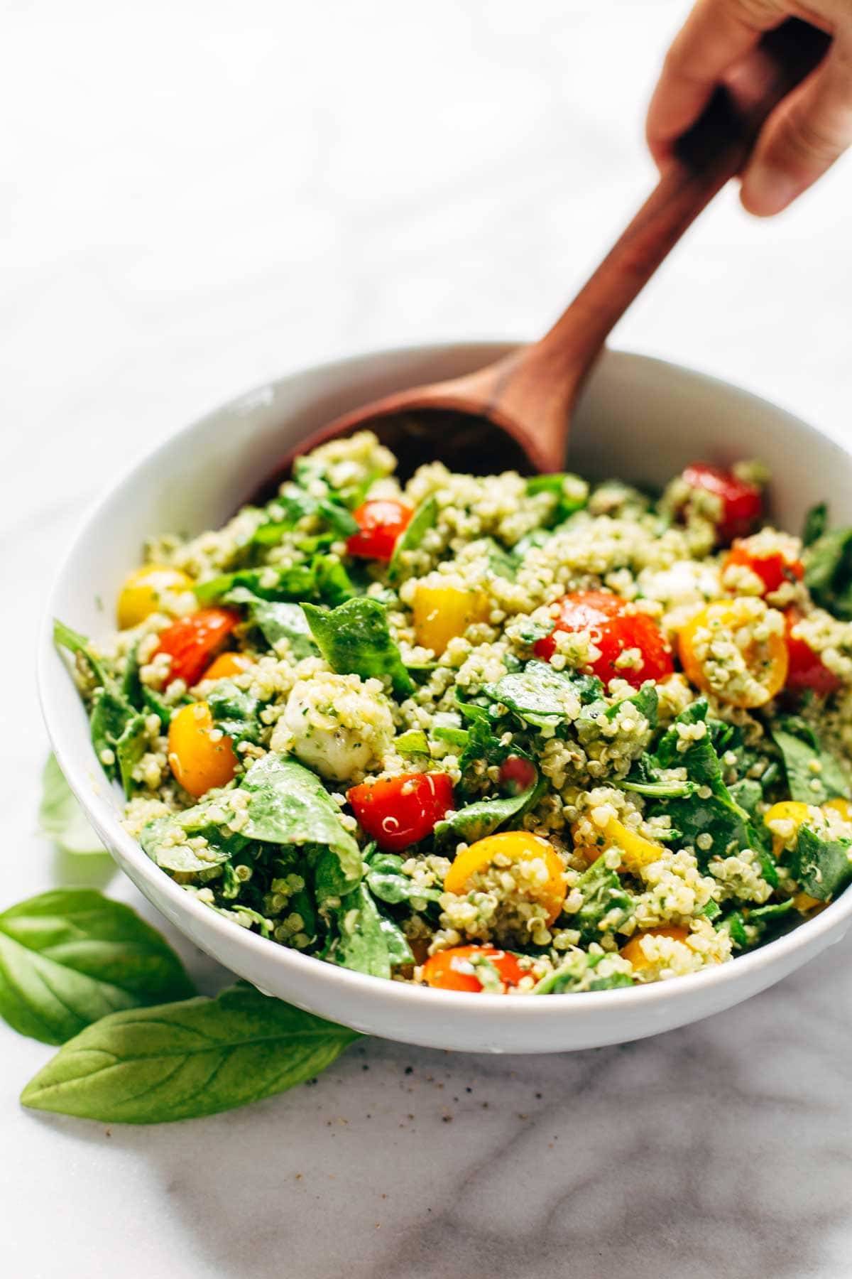 Green Goddess Quinoa Summer Salad in a bowl with a wooden spoon