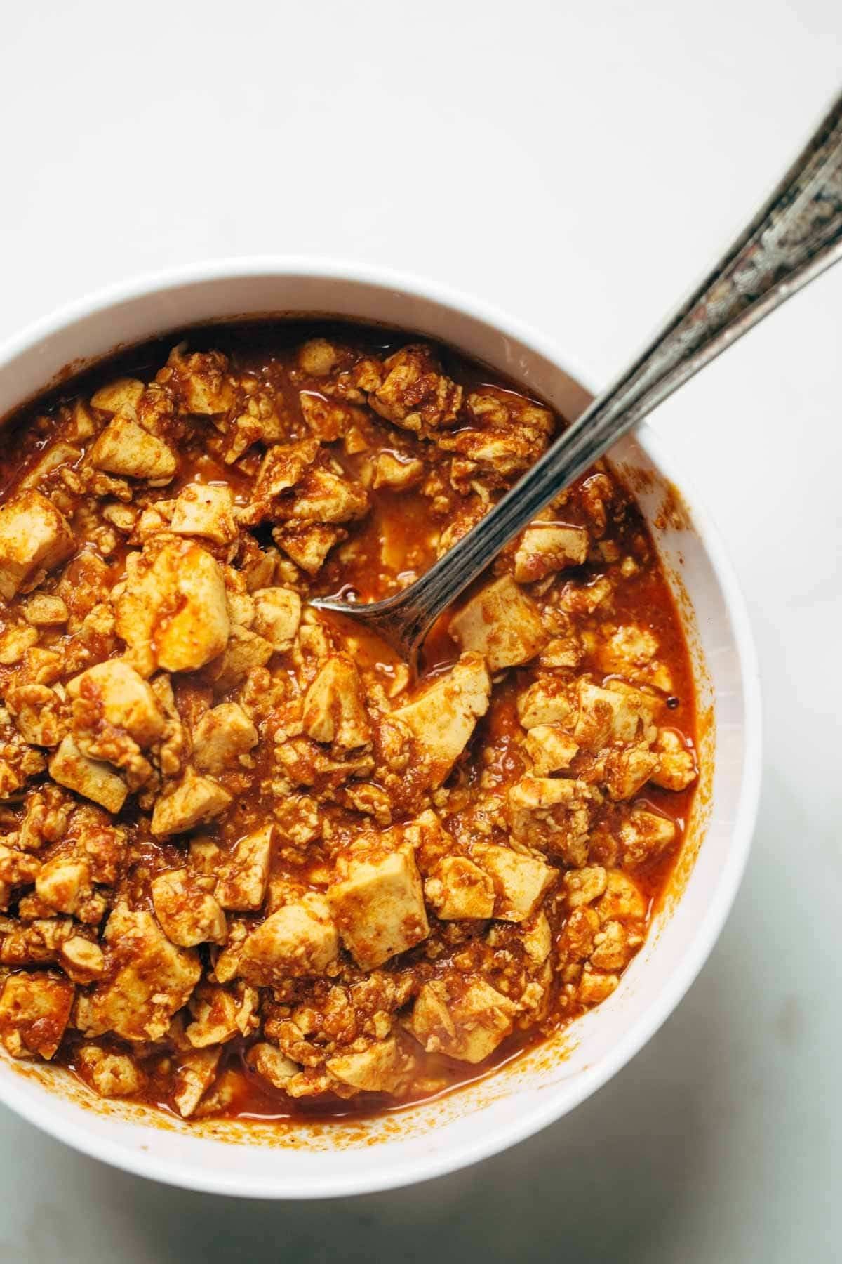 Sofritas Tofu in a bowl with a spoon.
