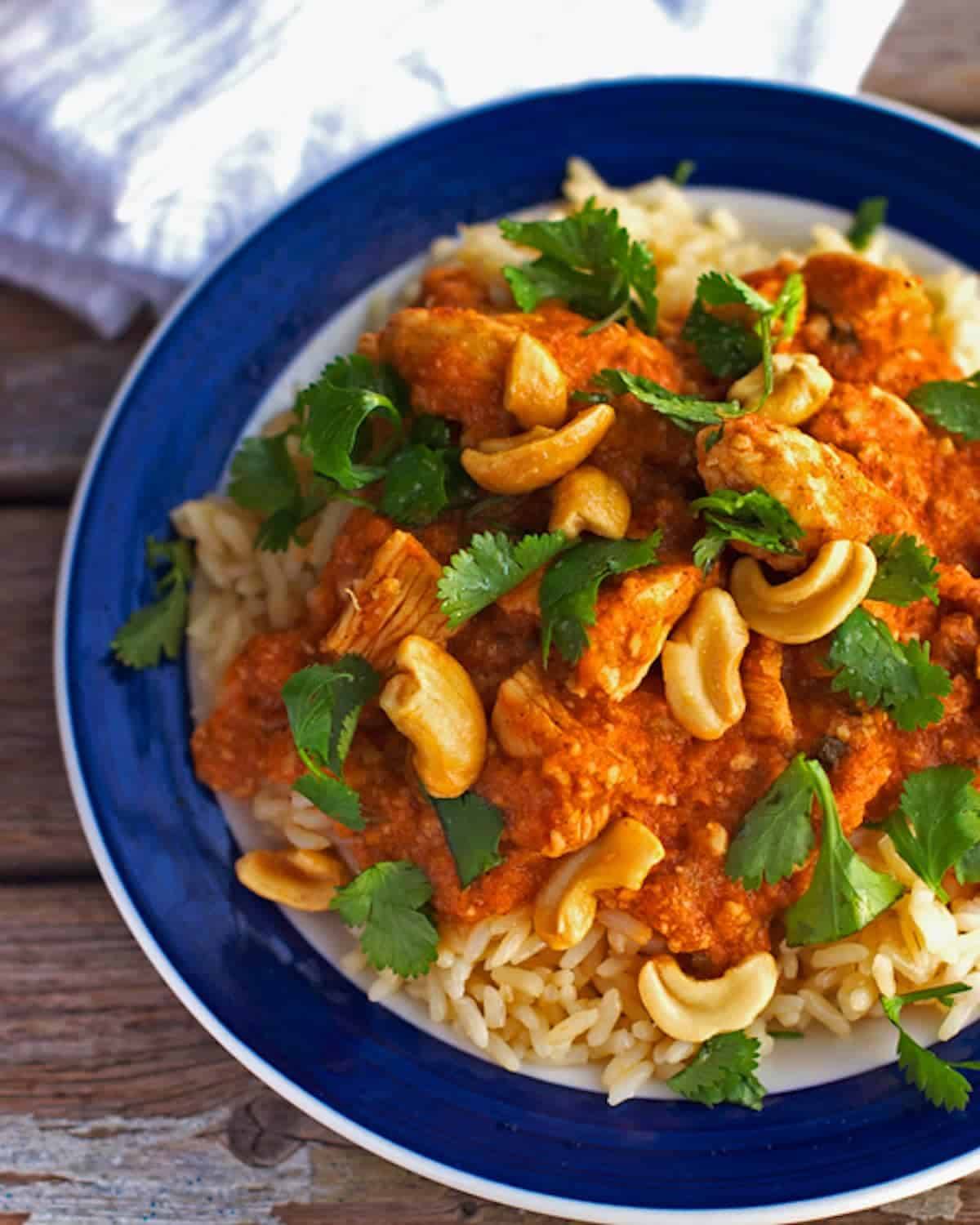 Cashew chicken in a blue and white bowl.
