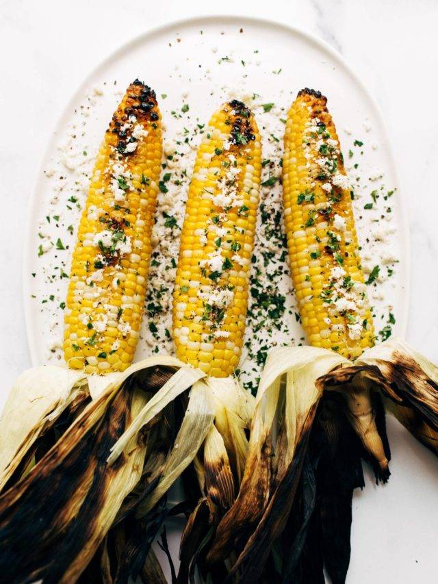 Three ears of grilled corn with cotija.