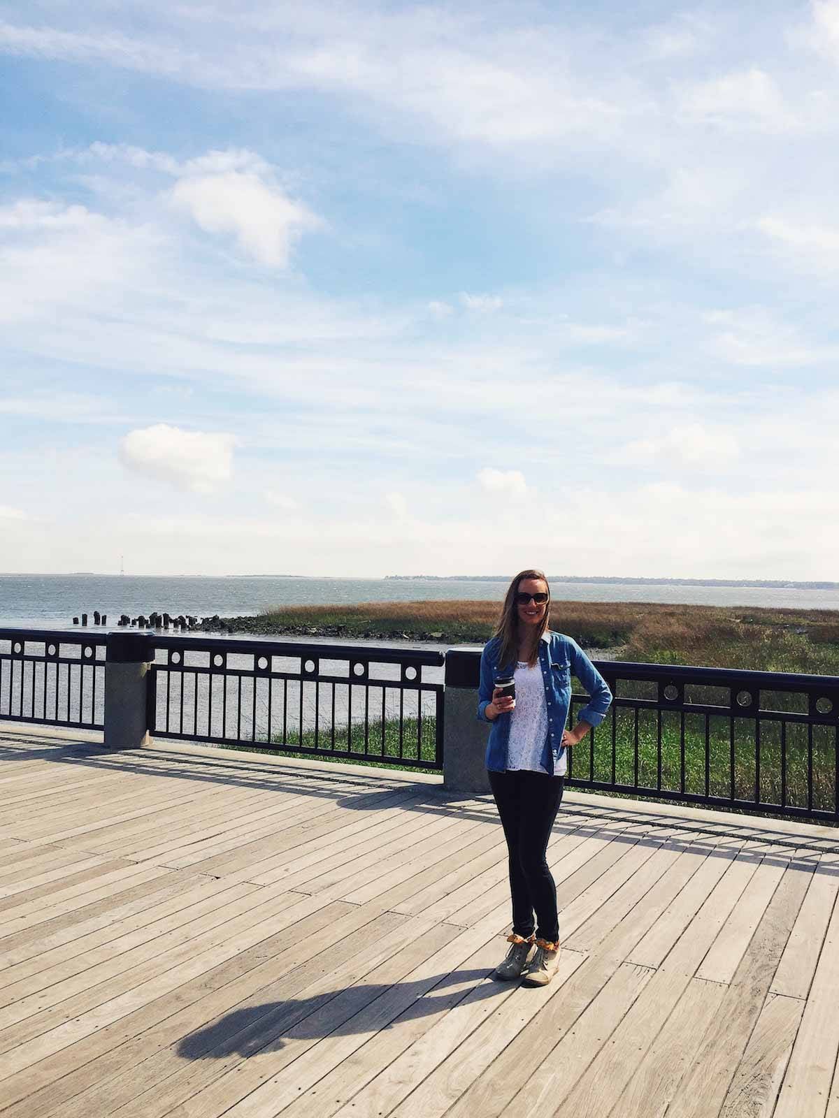 Woman standing on a boardwalk.
